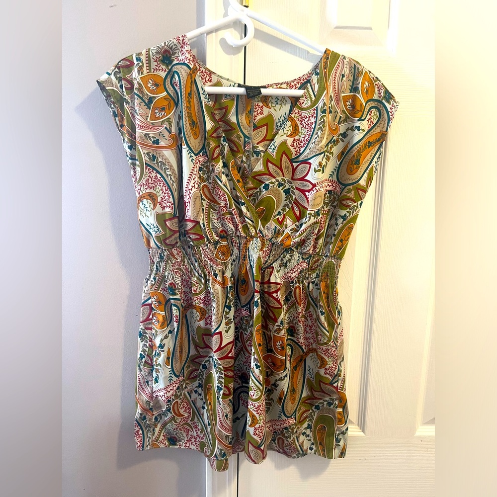 V-necked peplum blouse.  Multi-color paisley type print.
